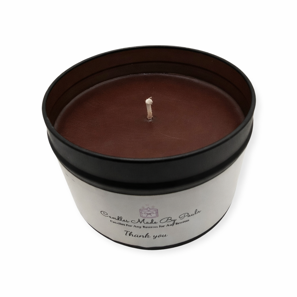 Candle in a black tin with a white label on a white background