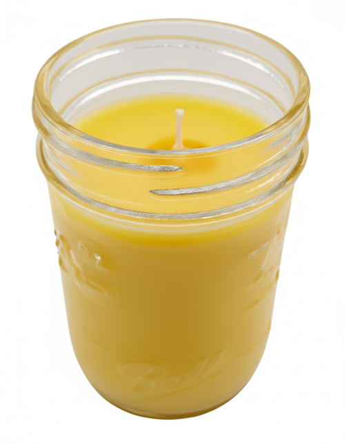 Yellow Citronella Candle in a glass clear jar on a white background