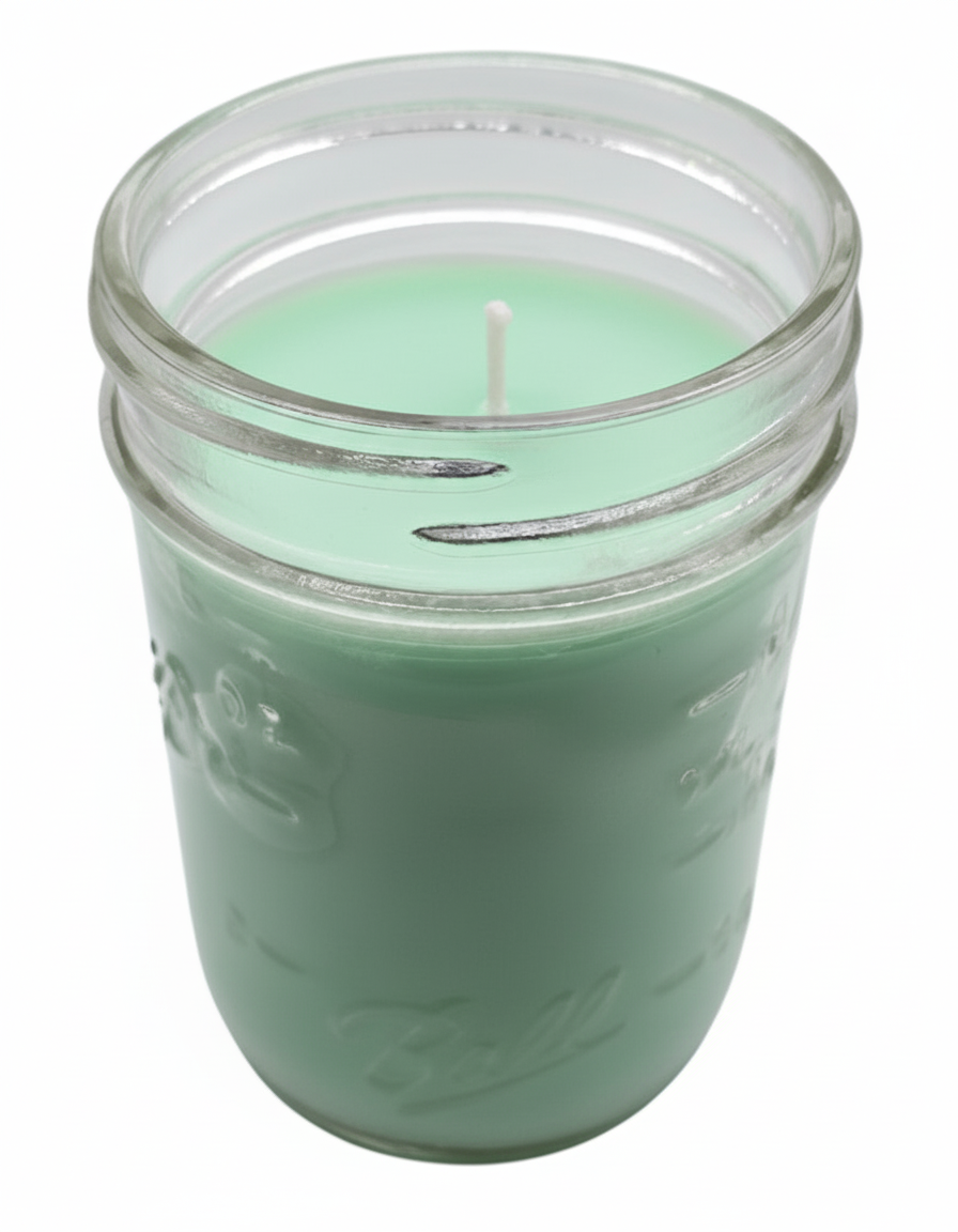 Green Citronella Candle in a glass clear jar on a white background
