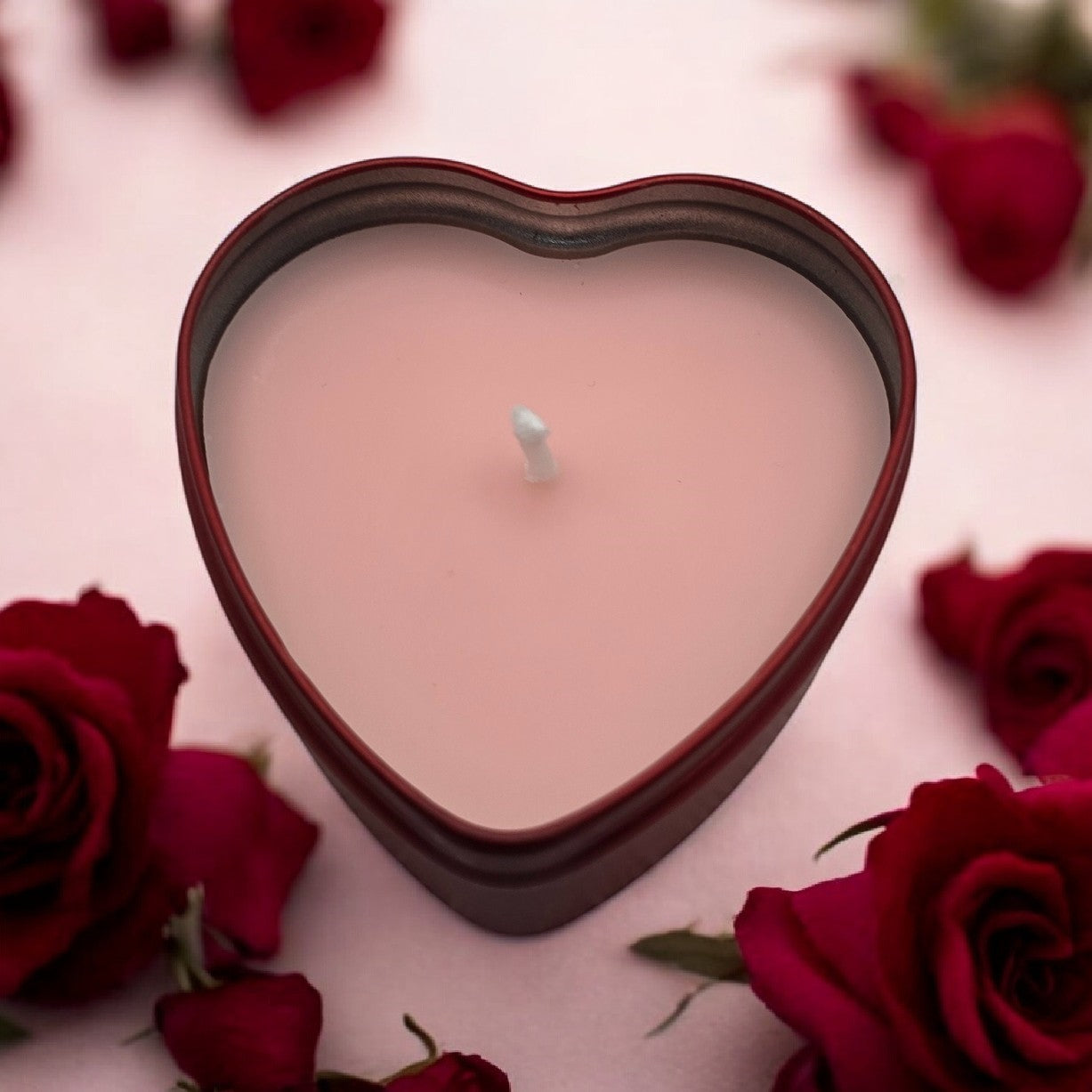 Pink heart-shaped candles in tin