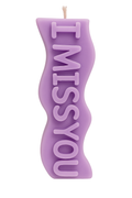 Purple candle shaped like a heart with 'I MISS YOU' text on a white background