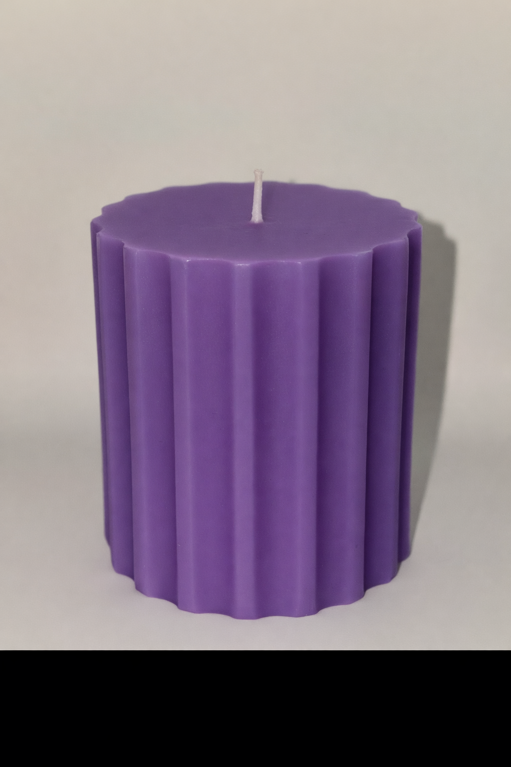 Purple handcrafted ribbed pillar candle made for elegant home styling.
