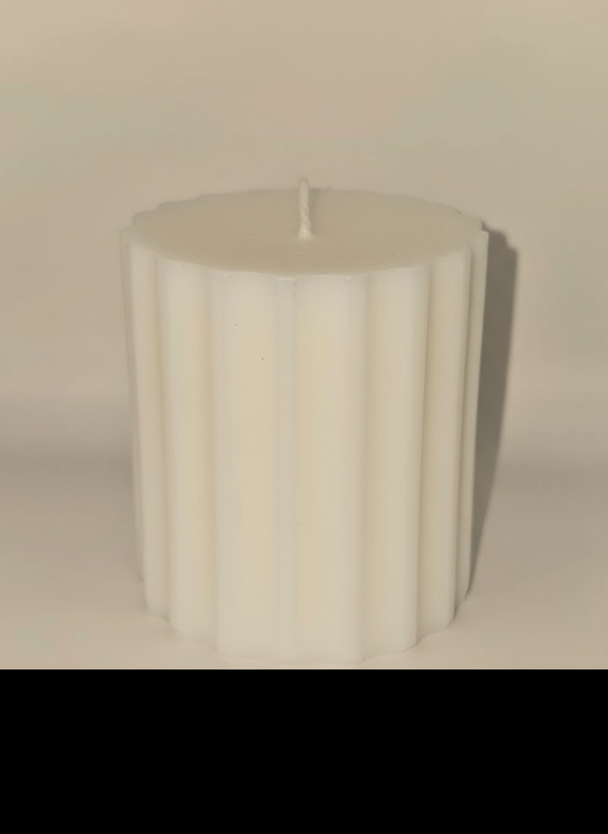 White handcrafted ribbed pillar candle made for elegant home styling.